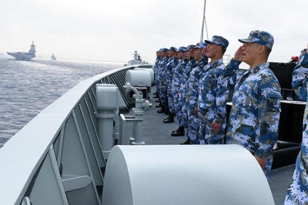 A PLA Navy fleet including the aircraft carrier Liaoning, submarines, vessels and fighter jets take part in a review in the South China Sea.