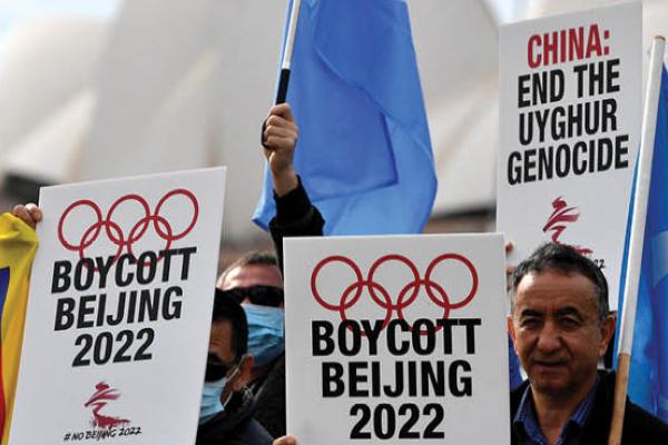 Protesters hold up placards and banners as they attend a demonstration in Sydney on June 23, 2021 to call on the Australian government to boycott the 2022 Beijing Winter Olympics over China's human rights record. (Getty Images)