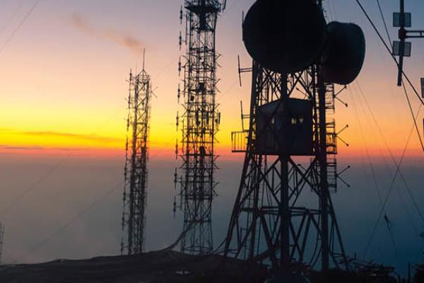 Signal receiving tower equipment at sunset. (Getty Images)