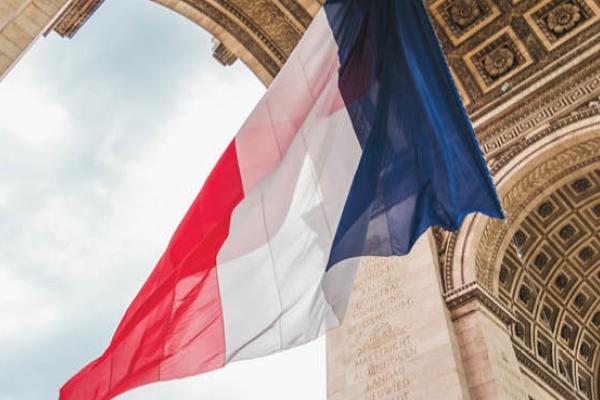 A French flag hangs from the Arc de Triomphe during the 100 Anniversary of the Tomb of the Unknown Soldier on November 11, 2020, in Paris, France. (Getty Images)