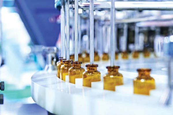 Glass medicine bottles on a production line. (Getty Images)