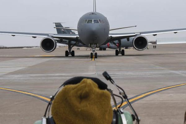 An Aircraft Maintenance Squadron crew chief marshals the KC-46A Pegasus on the flight line on February 21, 2019, at McConnell Air Force Base, Wichita, Kansas. (Alexi Myrick/US Air Force)