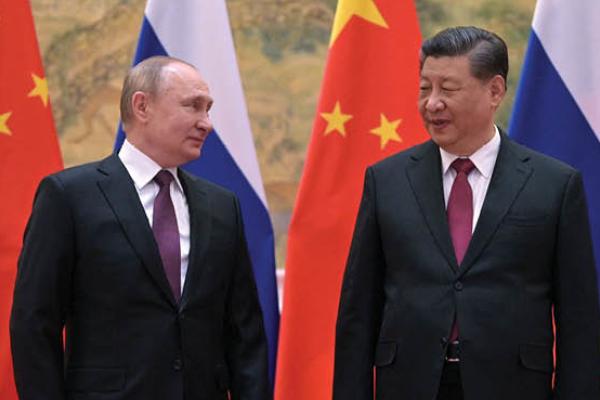 Russian President Vladimir Putin and Chinese President Xi Jinping pose during their meeting in Beijing, on February 4, 2022. (Getty Images)