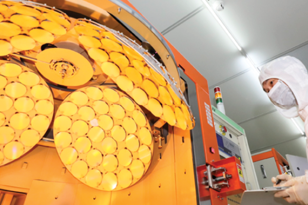 An employee works on the production line of LED epitaxial wafer on March 25, 2022, in Jiangsu Province, China. (Zhao Qirui/VCG via Getty Images)