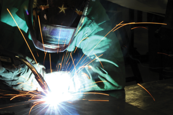 Staff Sgt. Neil Oltmer uses metallic inert gas welding to build a mounting plate on March 18, 2014, at McConnell Air Force Base, Kansas. (US Air Force photo/Airman 1st Class David Bernal Del Agua)