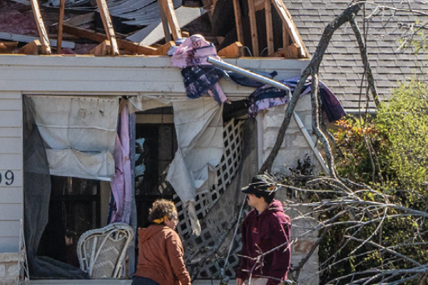 People look at their damaged house after tornados in Round Rock, Texas, on March 22, 2022. (Bo Lee/Xinhua via Getty Images)