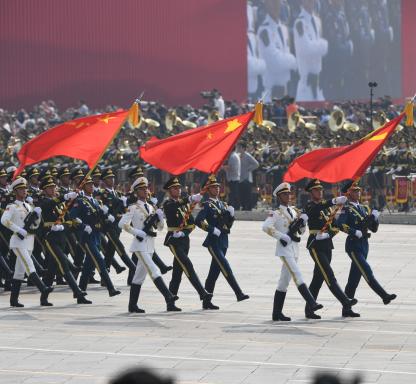Chinese soldiers march with the national flag (C), flanked by the flags of the Communist Party of China (R) and the People's Liberation Army (L) during a military parade at Tiananmen Square