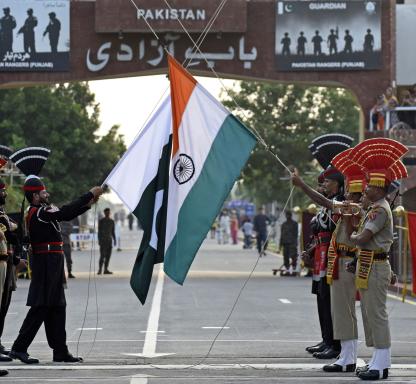 on August 1, 2022, Indian Border Security Force (BSF) soldiers (in brown) and Pakistani Rangers take part in the Beating the Retreat ceremony at the India-Pakistan Wagah border post, about 35 km from Amritsar.