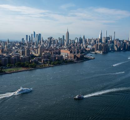 Boats move through the East River with the Manhattan skyline in the background during Labor Day Weekend in Williamsburg on September 03, 2022 in the Brooklyn Borough of New York City.