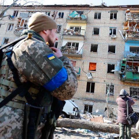 Residents outside a destroyed residential building by artillery in a residential area in Kyiv amid Russian Invasion, in Kyiv, Ukraine, 18 March 2022. (Photo by Ceng Shou Yi/NurPhoto via Getty Images)