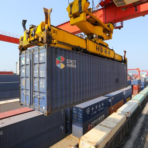 A large machine lifts containers at the China-Kazakhstan Logistics Cooperation Base in Lianyungang, China, on June 8, 2022. (CFOTO/Future Publishing via Getty Images)