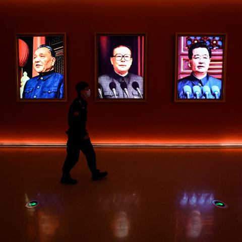 A man walks past portraits of Mao Zedong, Deng Xiaoping, Jiang Zemin, Hu Jintao, and current President Xi Jinping at Yanan Revolutionary Memorial Hallin Yanan, China, on October 15, 2022. (Jade Gao/AFP via Getty Images)