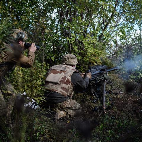 A soldier of Ukraine's 5th Regiment of Assault Infantry fires a US-made MK-19 automatic grenade launcher towards Russian positions in less than 800 metres away at a front line near Toretsk in the Donetsk region on October 12, 2022,