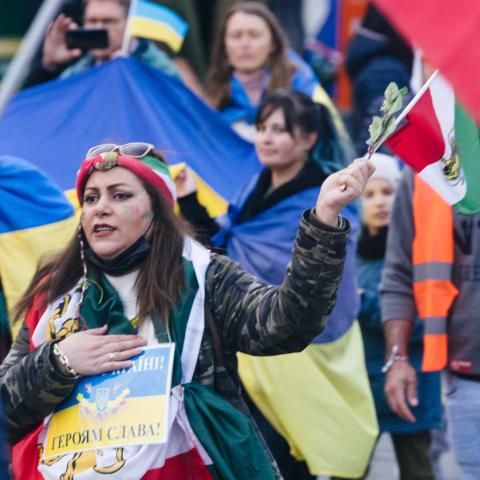 An Iranian woman holds both Ukrainian and Iranian flags at a demonstration for peace in Cologne, Germany, on November 5, 2022. (Ying Tang/NurPhoto via Getty Images)