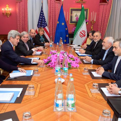 U.S. Secretary of State John Kerry -- flanked by Chief of Staff Jon Finer, Under Secretary of State for Political Affairs Wendy Sherman, U.S. Energy Secretary Dr. Ernest Moniz, National Security Council Senior Director for Iran, Iraq, Syria and the Gulf States Robert Malley, and European Union Deputy Secretary General Helga Schmid -- sits across from Iranian Foreign Minister Javad Zarif, Dr. Ali Akbar Salehi, the Vice President of Iran for Atomic Energy and President of the Atomic Energy Organization of Ira