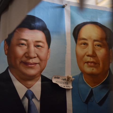 This photo taken on September 19, 2017 shows painted portraits of Chinese President Xi Jinping (L) and late communist leader Mao Zedong at a market in Beijing. As the Chinese Communist Party gathers for its most defining congress in decades, a new catchphrase is echoing through Beijing's cavernous Great Hall of the People: Xi Jinping's "new era thought". / AFP PHOTO / GREG BAKER (Photo credit should read GREG BAKER/AFP via Getty Images)