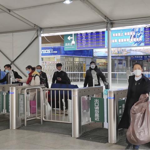 SHANGHAI, CHINA - DECEMBER 08: Travellers walk out of Shanghai Railway Station as Shanghai no longer requires people who return to this city to undergo nucleic acid testing upon their arrival on December 8, 2022 in Shanghai, China. (Photo by VCG/VCG via Getty Images)