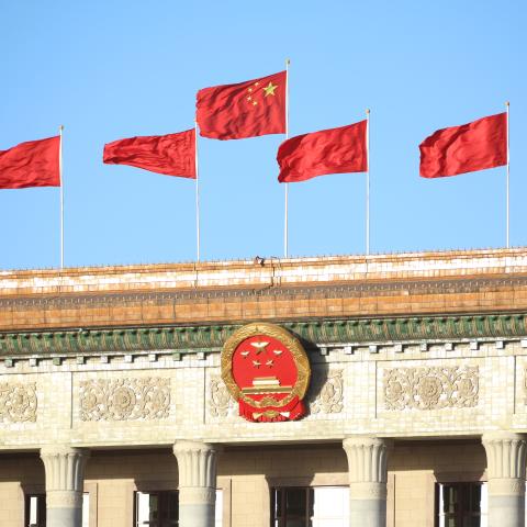 BEIJING, CHINA - OCTOBER 22: Chinese national flags flutter on the Great Hall of the People on October 22, 2022 in Beijing, China. The 20th CPC National Congress concluded on Saturday in Beijing. (Photo by VCG/VCG via Getty Images)