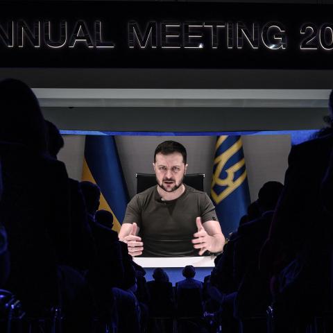President Volodymyr Zelensky appears on a giant screen during his remote address to the World Economic Forum annual meeting in Davos, Switzerland, on May 23, 2022. (Fabrice Coffrini/AFP via Getty Images)
