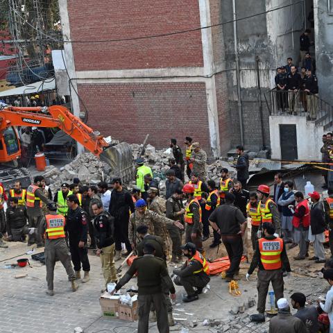 Security personnel and rescue workers prepare to search for the blast victims in the debris of a damaged mosque inside the police headquarters in Peshawar on January 30, 2023. - A blast at a mosque inside a police headquarters in Pakistan on January 30 killed at least 25 worshippers and wounded 120 more, officials said. (Photo by Abdul MAJEED / AFP) (Photo by ABDUL MAJEED/AFP via Getty Images)