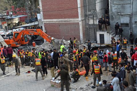 Security personnel and rescue workers prepare to search for the blast victims in the debris of a damaged mosque inside the police headquarters in Peshawar on January 30, 2023. - A blast at a mosque inside a police headquarters in Pakistan on January 30 killed at least 25 worshippers and wounded 120 more, officials said. (Photo by Abdul MAJEED / AFP) (Photo by ABDUL MAJEED/AFP via Getty Images)