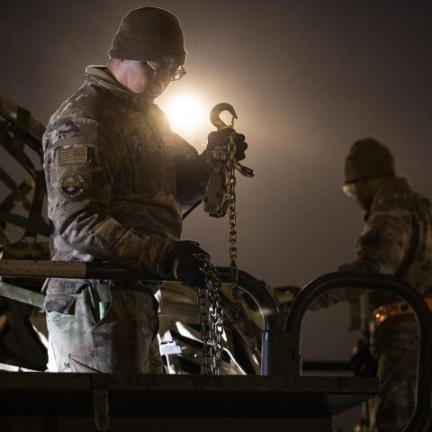 Senior Airmen Davonte Martinez, left, and Victor Davis, right, both 436th Aerial Port Squadron ramp operation specialists, load cargo during a security assistance mission at Dover Air Force Base, Delaware, Jan. 20, 2023. The Department of Defense is providing Ukraine with critical capabilities to defend against Russian aggression. (U.S. Air Force photo by Staff Sgt. Marco A. Gomez)