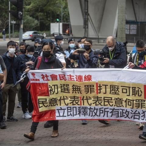 Protesters holding up a banner outside the West Kowloon Magistrates Court before the trial against 47 pro-democracy activists on February 6, 2023 in Hong Kong. (Vernon Yuen/NurPhoto via Getty Images)