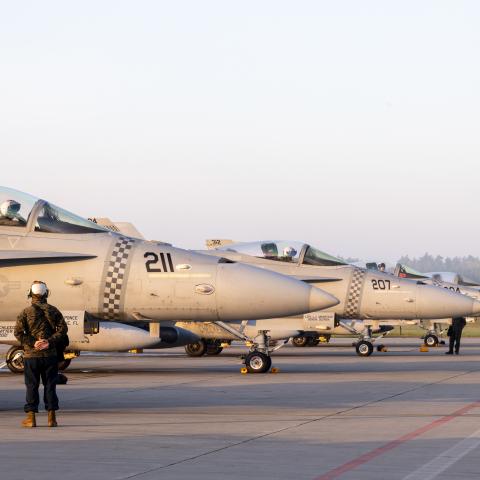 U.S. Marines with Marine Fighter Attack Squadron (VMFA) 312, 2nd Marine Aircraft Wing (MAW), prepare F/A-18 Hornets to take off for flight from Łask Air Base, Poland, April 27, 2022. 2nd Marine Aircraft Wing units are deployed to enhance NATO's capabilities in Eastern Europe at the invitation of the host nation. (U.S. Marine Corps photo by Cpl. Adam Henke)