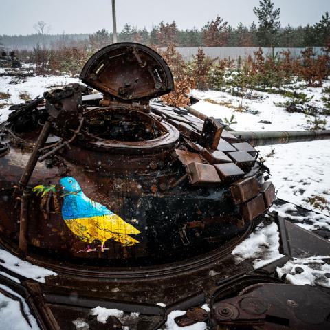 A photograph shows a street-art piece by Italian urban artist Tvboy on a destroyed Russian tank near the village of Dmytrivka, outside Kyiv, on February 1, 2023