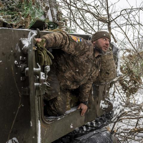 A Ukrainian army artillery crew dismounts from a self-propelled 122mm Howlitzer after firing on a Russian position on February 18, 2023 near Bakhmut, Ukraine. The army's 93rd Brigade's heavy artillery is a main element of the Ukrainian defense of the city, which is under heavy attack by Russian forces. (Photo by John Moore/Getty Images)