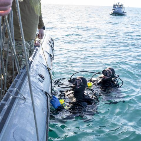 A sailor assigned to Explosive Ordnance Disposal Group 2 conduct pre-dive checks during recovery efforts of a high-altitude balloon in the Atlantic Ocean on February 7, 2023. (US Navy photo by Ryan Seelbach)