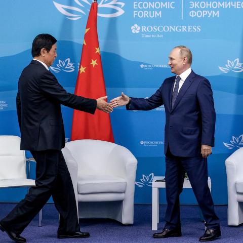 Vladimir Putin shakes hands with Chairman of the Standing Committee of the National People’s Congress of China Li Zhanshu at the Eastern Economic Forum in Primorye, Russia, on September 7, 2022, on the heels of the Vostok 2022 joint military exercises between Russia and China.