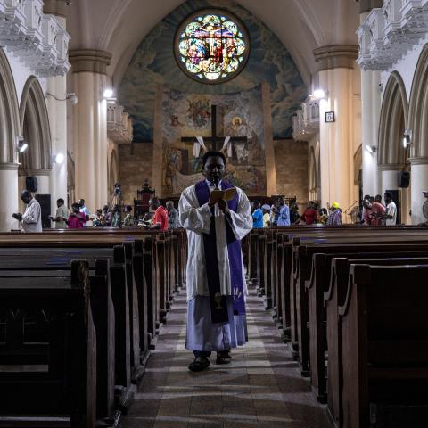A priest recites the stations of the cross prayers at the Holy Cross Cathedral in Lagos, Nigeria, on February 24, 2023. (John Wessels/AFP via Getty Images)