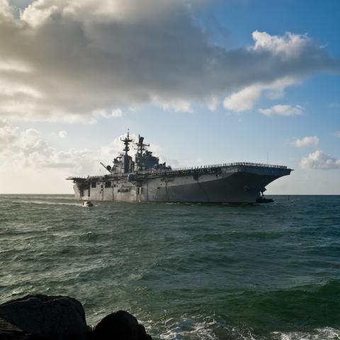 Morning sun illuminates the USS Iwo Jima (LHD-7) as she sails into Port Everglades in Fort Lauderdale, Florida. (JSABBOTT via Getty Images)