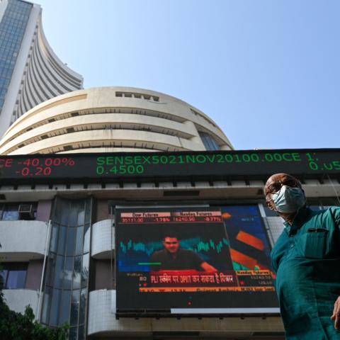 A pedestrian walks past the Bombay Stock Exchange (BSE) building in Mumbai on November 26, 2021. (Photo by PUNIT PARANJPE/AFP via Getty Images)