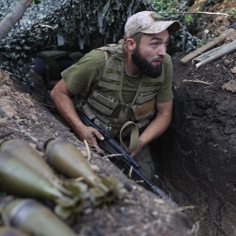A Ukrainian soldier walks along a trench at a position along the front line in the Donetsk region on August 15, 2022. (Anatolii Stepanov/AFP via Getty Images)