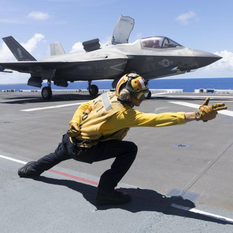 U.S. Navy Aviation Boatswain’s Mate (Handling) 3rd Class Nicolas Fareri launches a U.S. Marine Corps F-35B Lightning II aircraft with Marine Fighter Attack Squadron 121 off the amphibious assault carrier USS Tripoli (LHA 7) during Valiant Shield 2022 (VS22), June 13, 2022. Exercises such as Valiant Shield allows the Indo-Pacific Command Joint Task Force the opportunity to integrate forces from all branches of service to conduct long-range, precise, lethal, and overwhelming multi-axis, multi-domain effects t