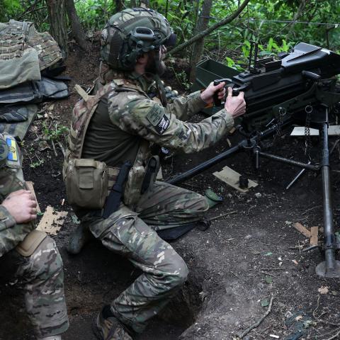 A Ukrainian soldier of the 28th Separate Mechanized Brigade fires a 40mm grenade launcher at the front line near Bakhmut, Ukraine, on June 17, 2023. (Photo by Anatolii Stepanov/AFP via Getty Images)