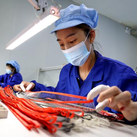 A worker produces high-voltage silicon stack devices at a semiconductor manufacturing enterprise in Shandong, China, on July 17, 2023. (CFOTO/Future Publishing via Getty Images)