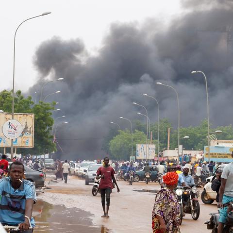 Smoke rises after coup supporters set fire to the headquarters of President Mohamed Bazoum's party, the Party for Democracy and Socialism in Niger (PNDS-TARAYA) in Niamey, Niger on July 27, 2023. (Photo by Balima Boureima/Anadolu Agency via Getty Images)