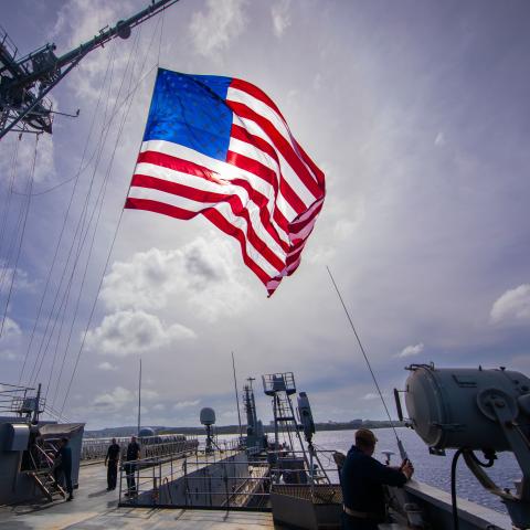 The submarine tender USS Emory S. Land (AS 39) flies the national ensign during the Marine Corps Base (MCB) Camp Blaz Reactivation and Naming Ceremony, Jan. 26. (U.S. Navy photo by Mass Communication Specialist Seaman Luke Wilson)