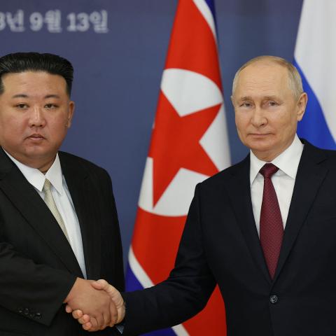 Russian President Vladimir Putin and North Korea's leader Kim Jong Un shaking hands on September 13, 2023. (Vladimir Smirnov/Pool/AFP via Getty Images)