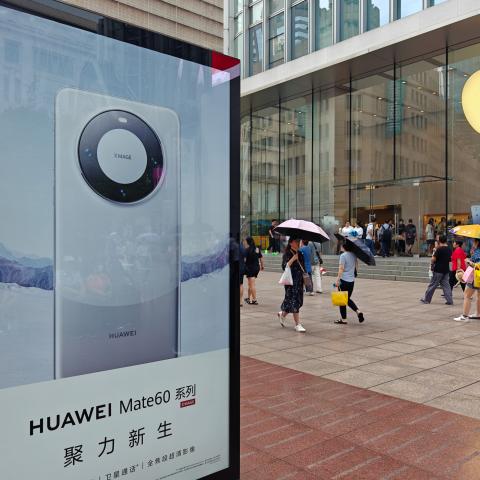 A light box advertising Huawei Mate 60 mobile phone is seen in front of the Apple store on Nanjing Road in Shanghai, China, on September 13, 2023. (CFOTO/Future Publishing via Getty Images)