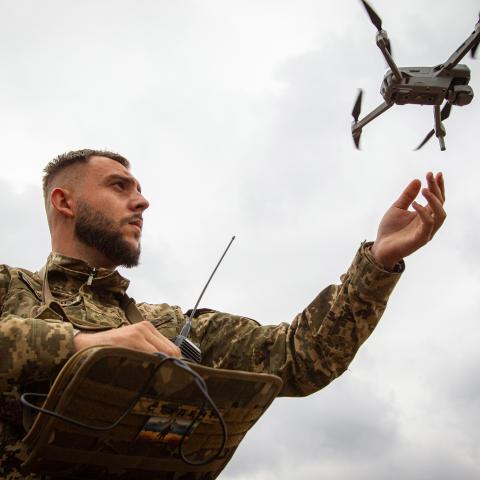 A serviceman launches a drone during a press tour to demonstrate the integration of AI into the process of humanitarian demining in the Zhytomyr Region, northern Ukraine, on September 20, 2023. (Kirill Chubotin/Ukrinform/Future Publishing via Getty Images)