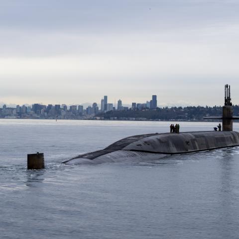 The Ohio-class ballistic missile submarine USS Louisiana (SSBN 743) transits Puget Sound past the Seattle skyline on February 9, 2023. (US Navy photo by Mass Communication Specialist Brian G. Reynolds)
