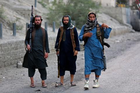 Armed Taliban security personnel near the closed gates of a border crossing between Afghanistan and Pakistan in Nangarhar, Afghanistan, on September 6, 2023. (Shafiullah Kakar/AFP via Getty Images)