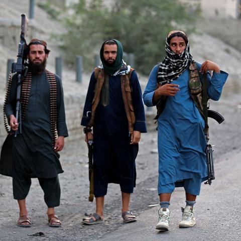 Armed Taliban security personnel near the closed gates of a border crossing between Afghanistan and Pakistan in Nangarhar, Afghanistan, on September 6, 2023. (Shafiullah Kakar/AFP via Getty Images)