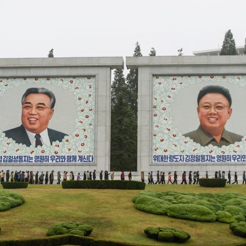 People line up to visit huge portraits of late North Korean leaders Kim Il Sung and Kim Jong Il, on the occasion of the 78th founding anniversary of the Workers' Party of Korea (WPK) in Pyongyang on October 10, 2023. (Photo by KIM Won Jin / AFP) (Photo by KIM WON JIN/AFP via Getty Images)