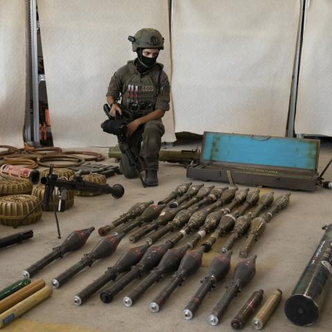  An Israeli soldier displays military equipment and ammunition that Hamas and Palestinans militants used at the time of the attack on the Israeli south border with the Gaza Strip on October 20, 2023 in Kiryat Malakhi, Israel. As Israel prepares to invade the Gaza Strip in its campaign to vanquish Hamas, the Palestinian militant group that launched a deadly attack in southern Israel on October 7th, worries are growing of a wider war with multiple fronts, including at the country's northern border with Lebano