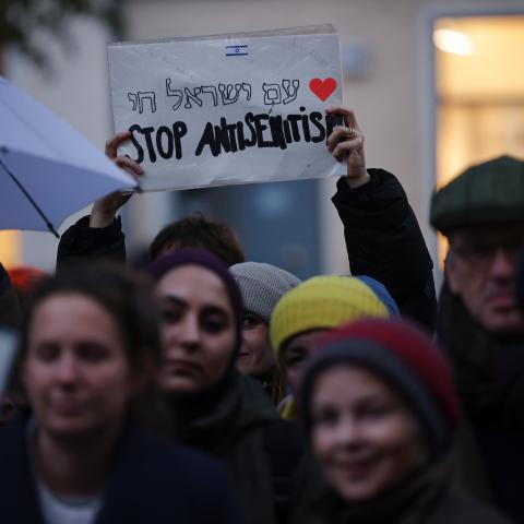 A participant holds a sign that reads "Stop Antisemitism" during a vigil outside the community center and synagogue of the Kahal Adass Jisroel Orthodox Jewish community on October 20, 2023, in Berlin, Germany. (Sean Gallup via Getty Images)